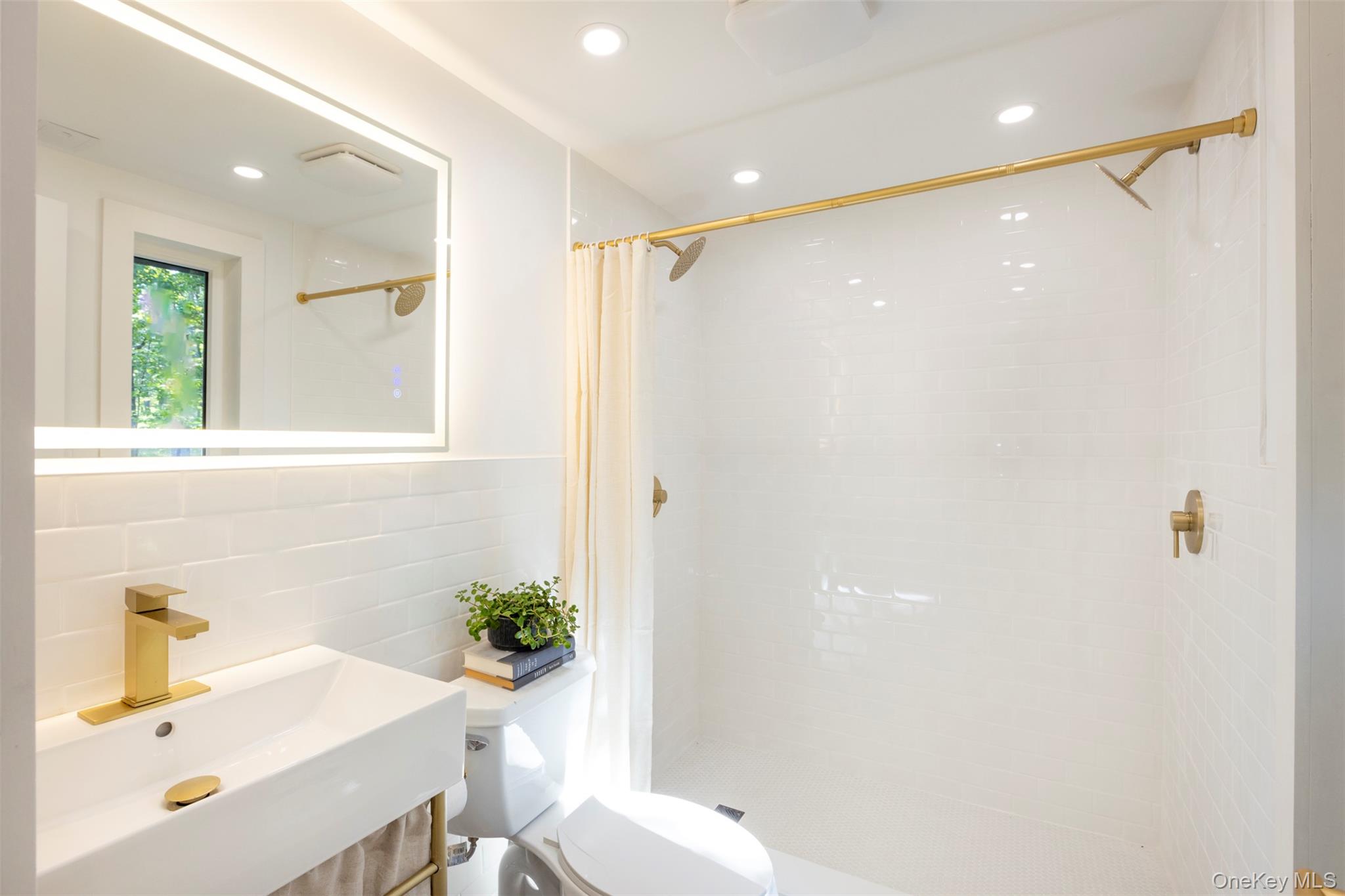 83 Sages Loop Road Kerhonkson, NY 12446 - Photo 20 of 33 a bathroom with a sink a toilet and shower
