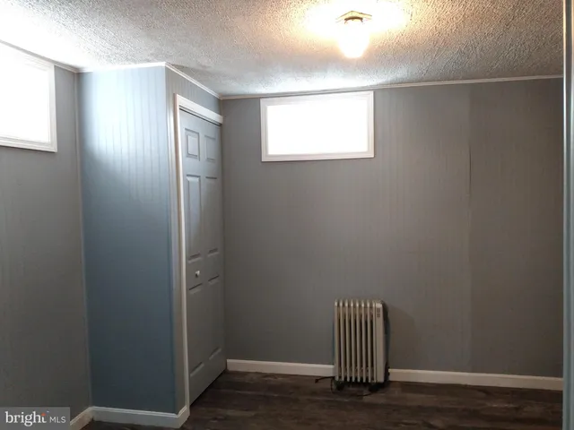 a view of room with wooden floor