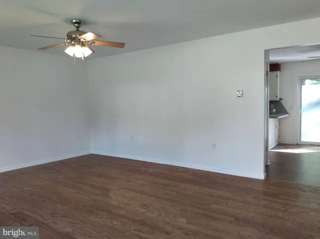a view of wooden floor and a chandelier in a room
