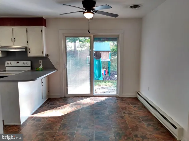 a kitchen with stainless steel appliances granite countertop a stove a refrigerator and a sink with granite countertops