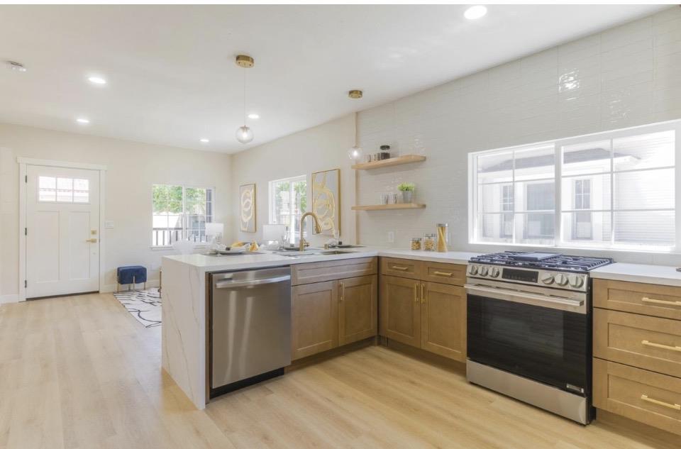735 Locust Street San Jose, CA 95110 - Photo 12 of 21 a kitchen with stainless steel appliances granite countertop a stove and a sink