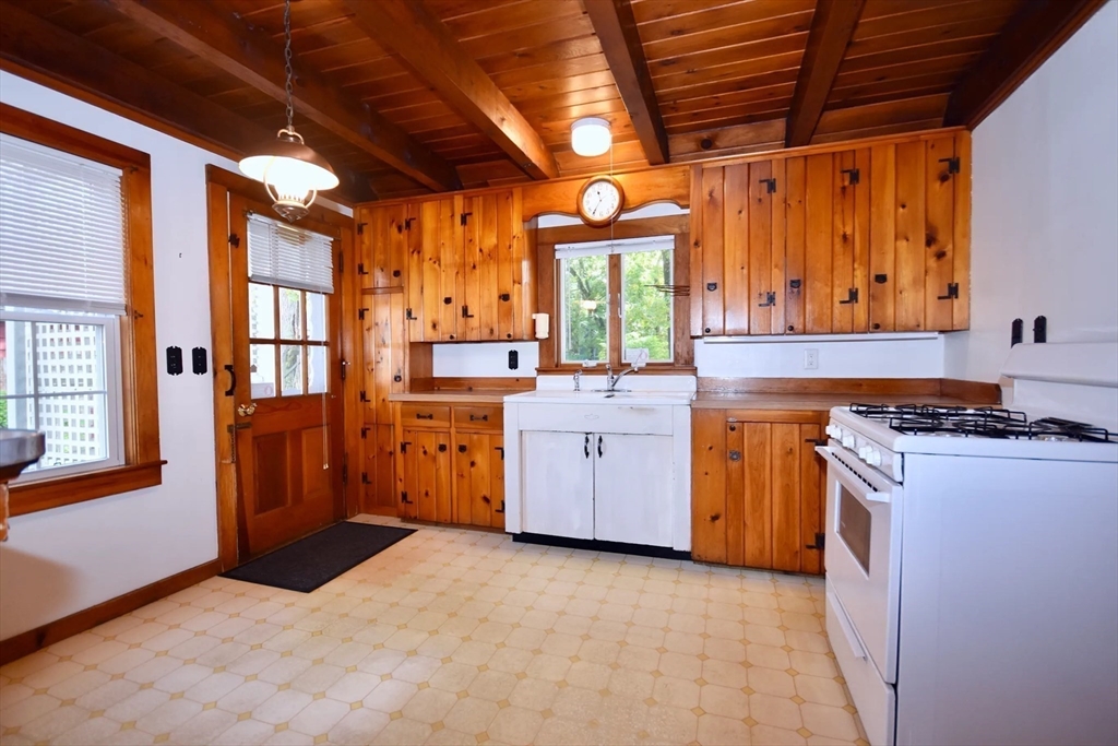 58 Main Avenue Wareham, MA 02558 - Photo 11 of 39 a kitchen with a stove window and cabinets