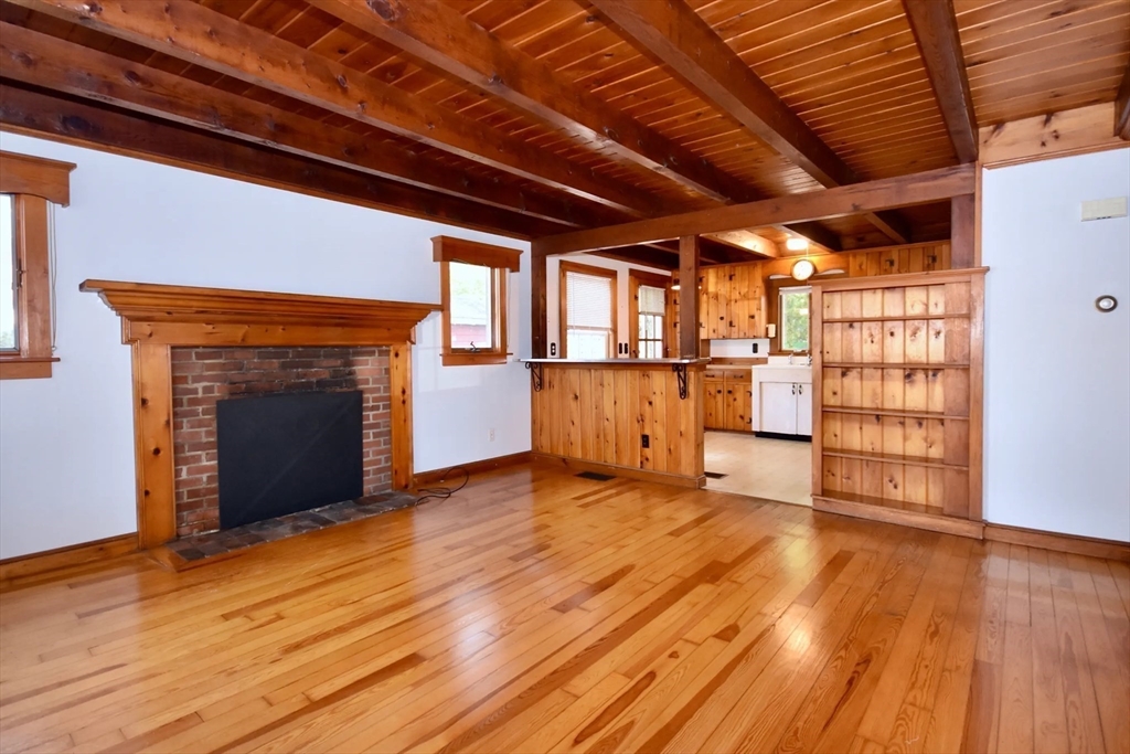 58 Main Avenue Wareham, MA 02558 - Photo 6 of 39 a view of empty room with wooden floor and fireplace