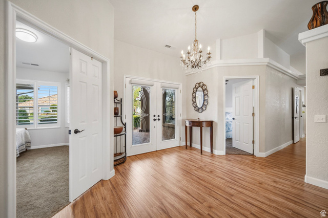 1985 West Rivers Edge Lane St. George, UT 84770 - Photo 12 of 42 Foyer entrance featuring light wood-style flooring, a chandelier, and french doors