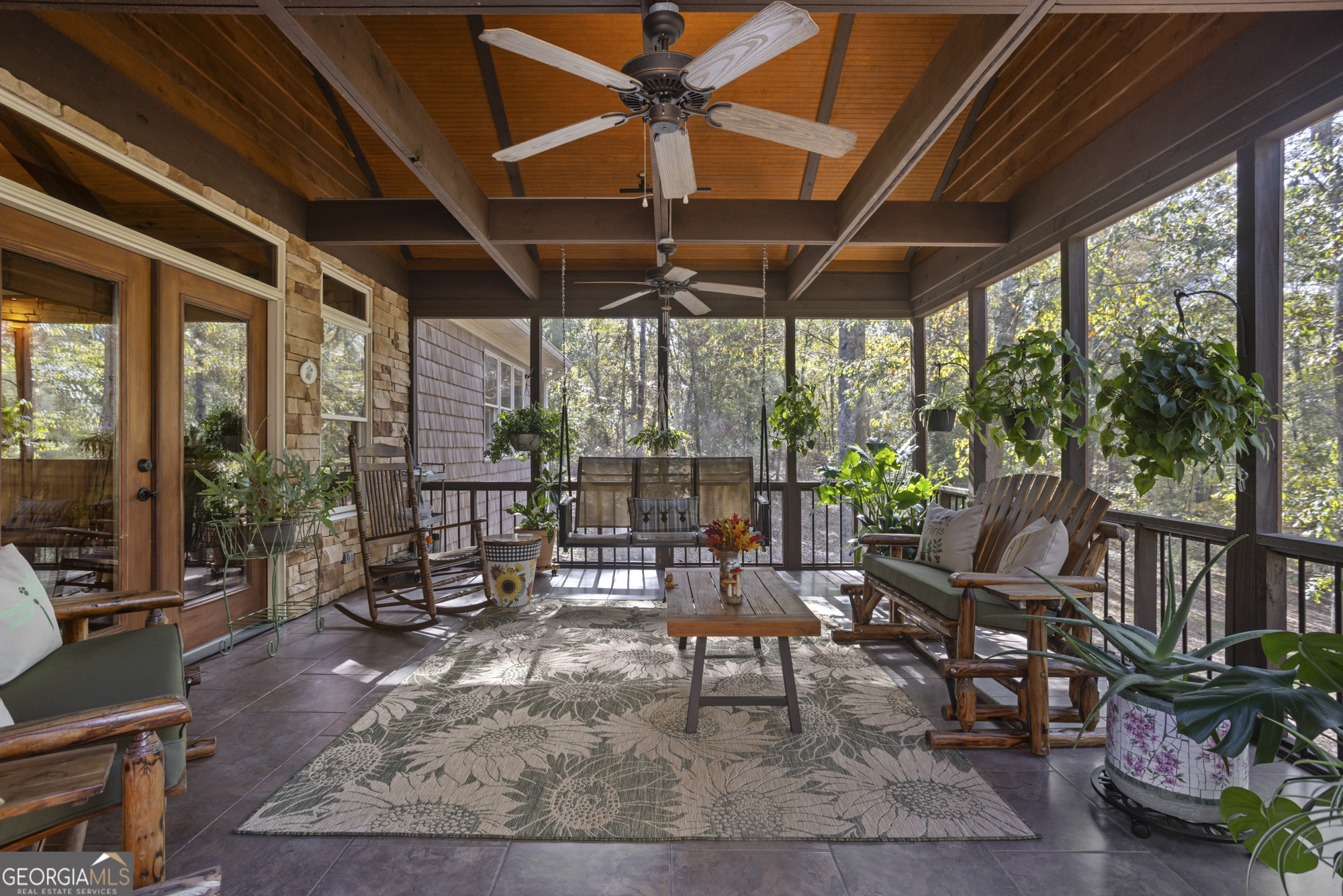 2690 East Lawson Merritt Road Fort Valley, GA 31030 - Photo 2 of 23 a view of a patio with table and chairs potted plants and floor to ceiling window with potted plants