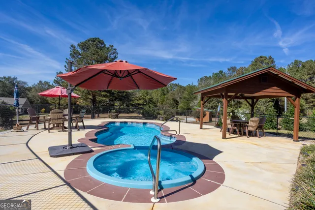 an aerial view of house with yard swimming pool and outdoor seating