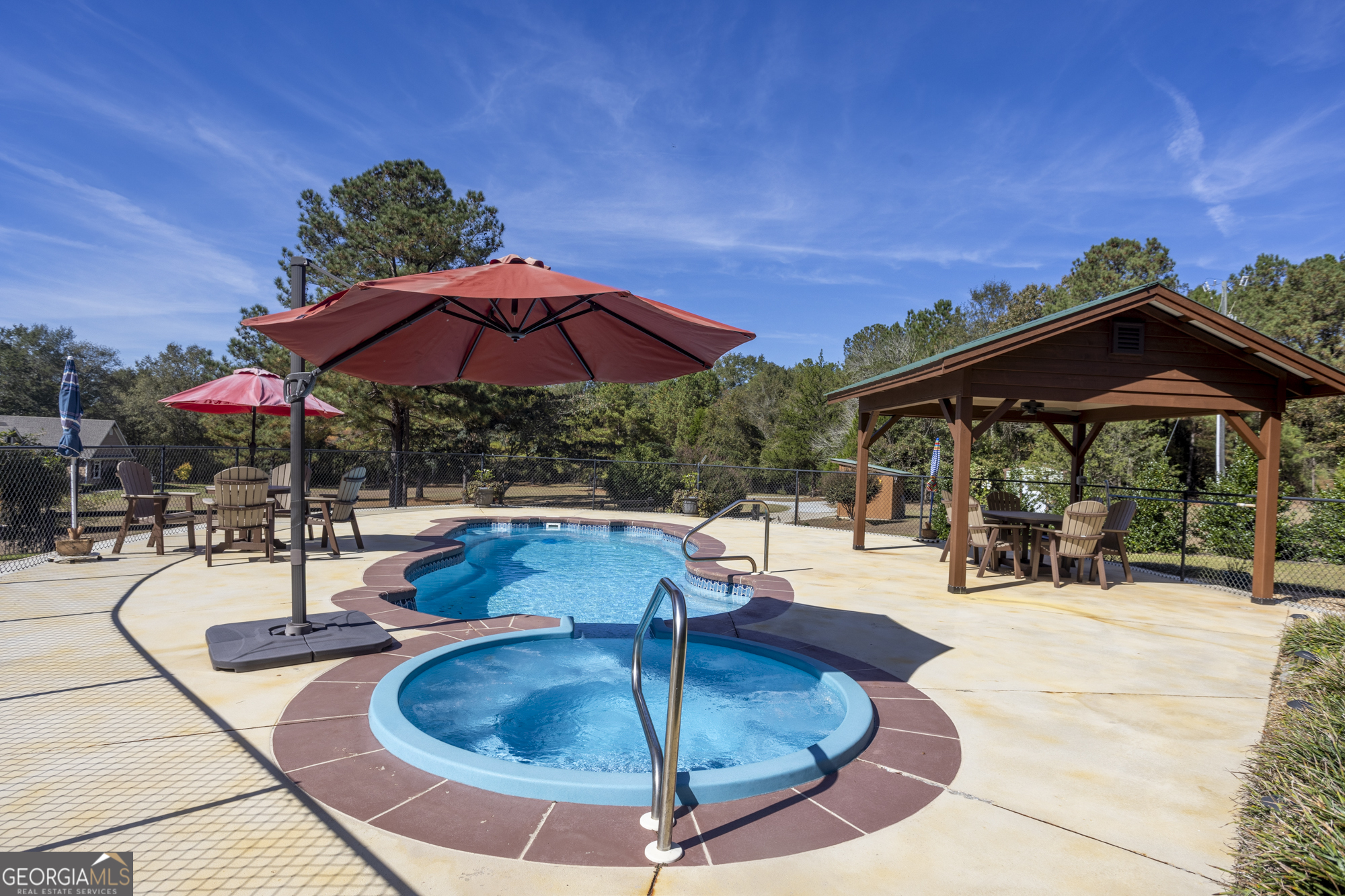 2690 East Lawson Merritt Road Fort Valley, GA 31030 - Photo 21 of 23 a view of a swimming pool with sitting area