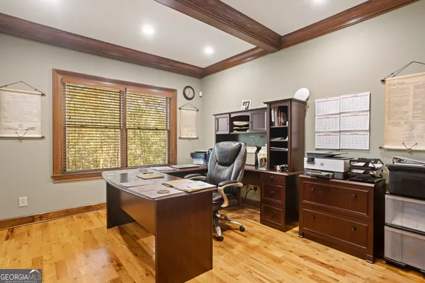 a view of a workspace with furniture and a window