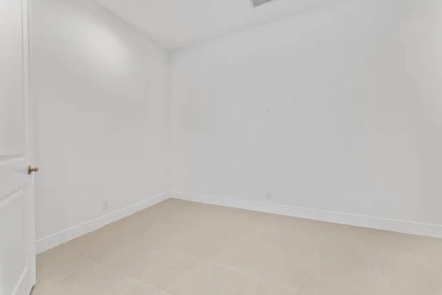 a kitchen with white cabinets and appliances