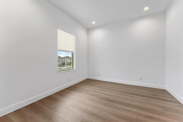 a bathroom with a granite countertop sink a toilet a mirror and bathtub