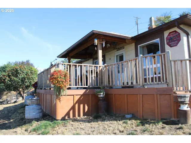 a view of a house with wooden fence