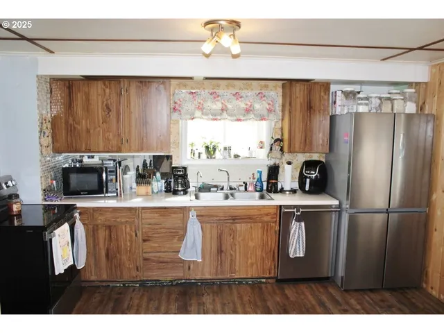 a kitchen with kitchen island a sink cabinets and window
