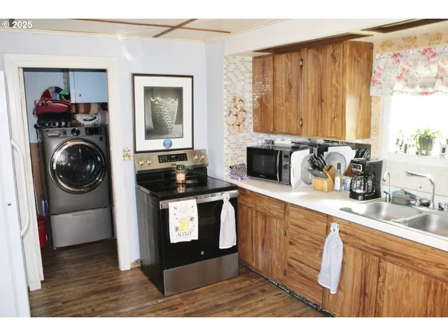 a kitchen with a stove a sink and a microwave
