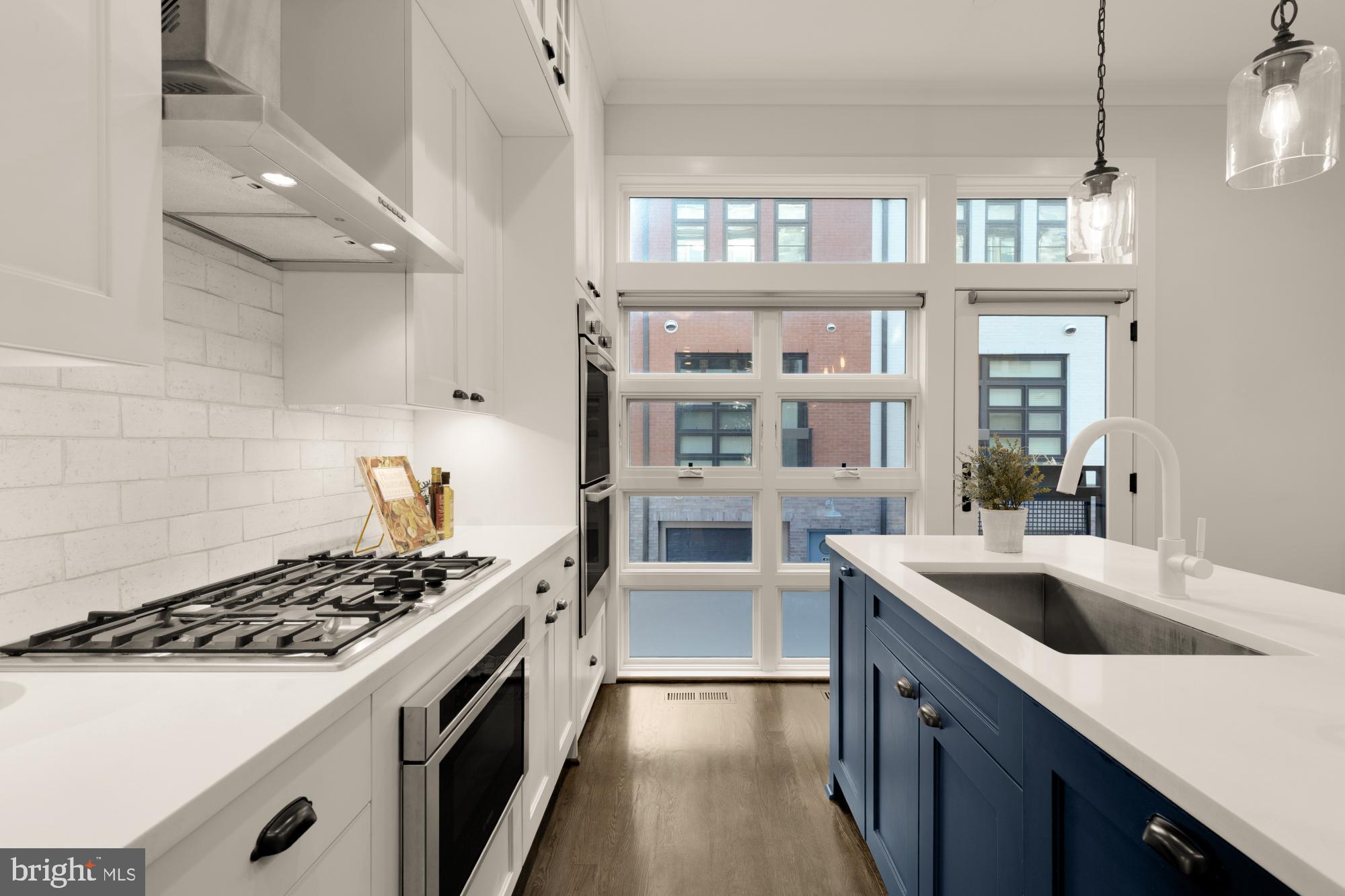 412 13th Street Southeast Washington, DC 20003 - Photo 11 of 62 a kitchen with stainless steel appliances a sink stove and cabinets