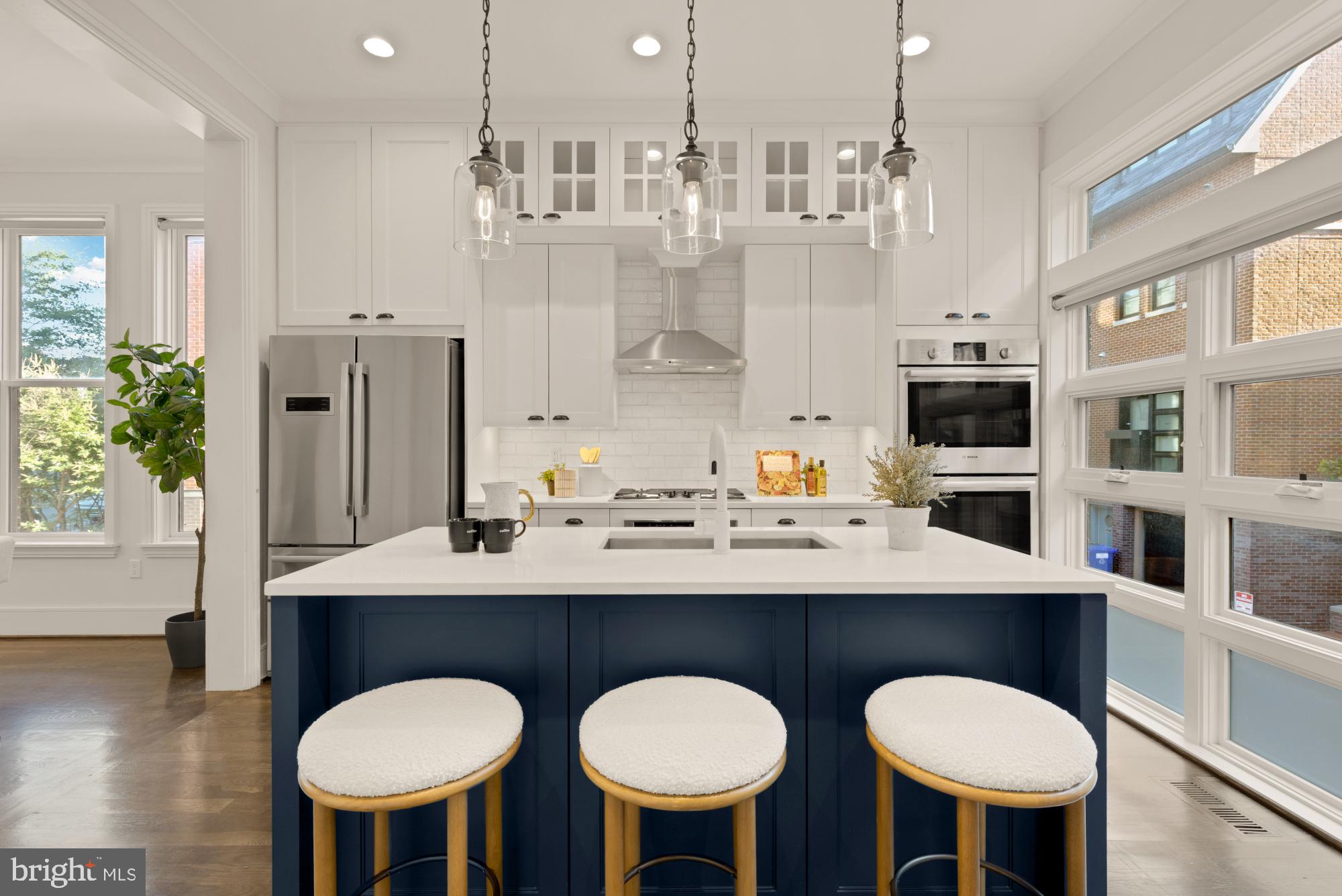 412 13th Street Southeast Washington, DC 20003 - Photo 15 of 62 a kitchen with stainless steel appliances a sink and a dining table with chairs