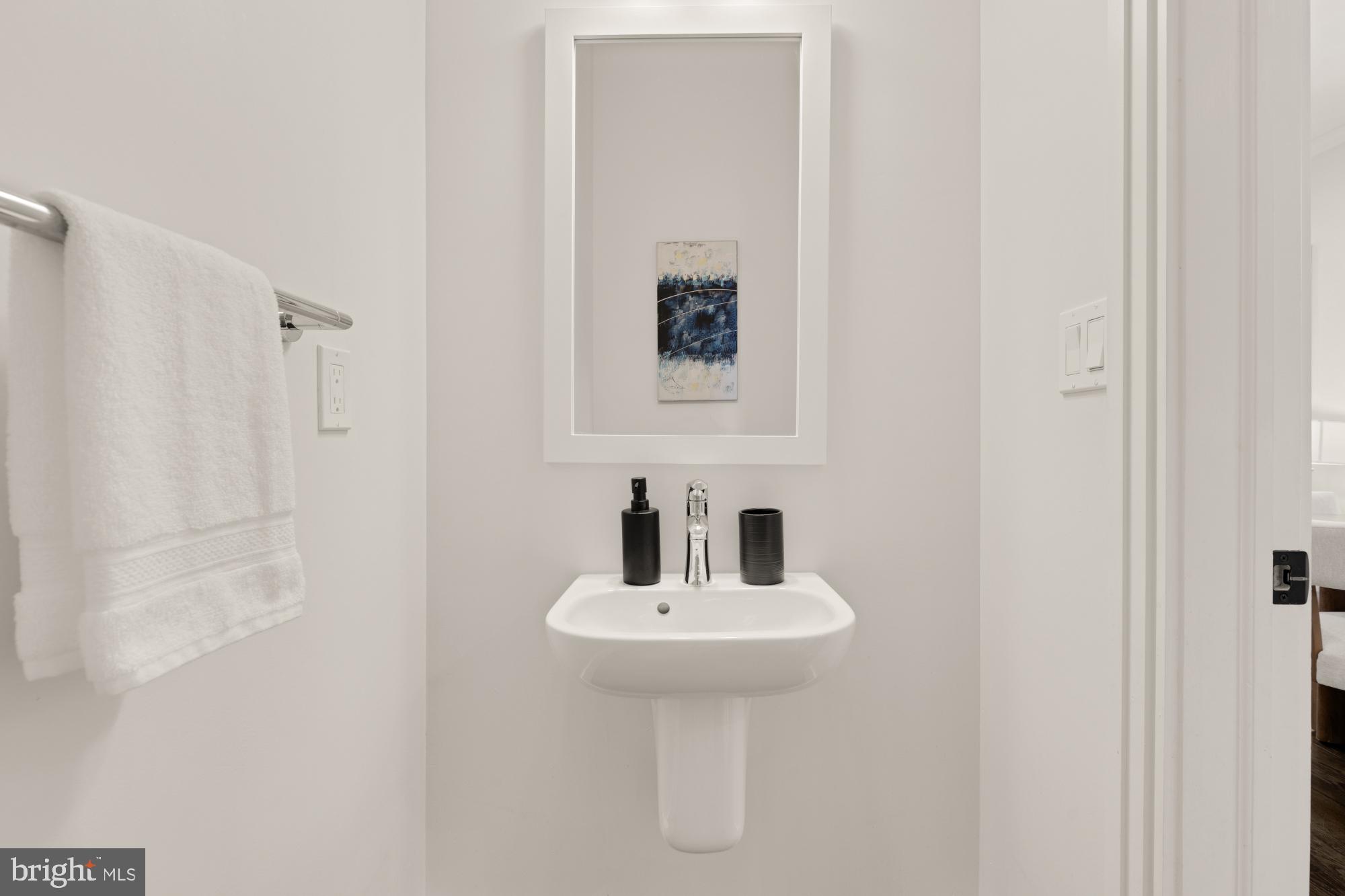 412 13th Street Southeast Washington, DC 20003 - Photo 17 of 62 a bathroom with a sink and a mirror