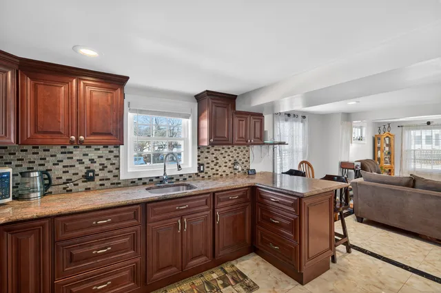 a kitchen with stainless steel appliances sink cabinets and window