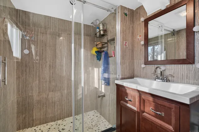 a bathroom with a sink vanity and a mirror