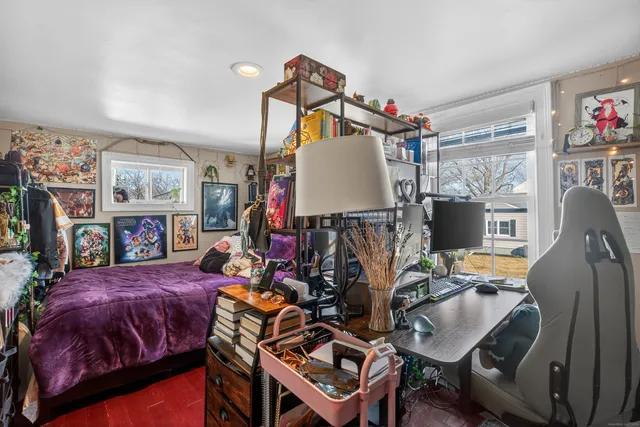 a bedroom with furniture and a wooden floor