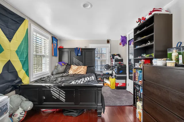 a bed room with a bed and a flat screen tv