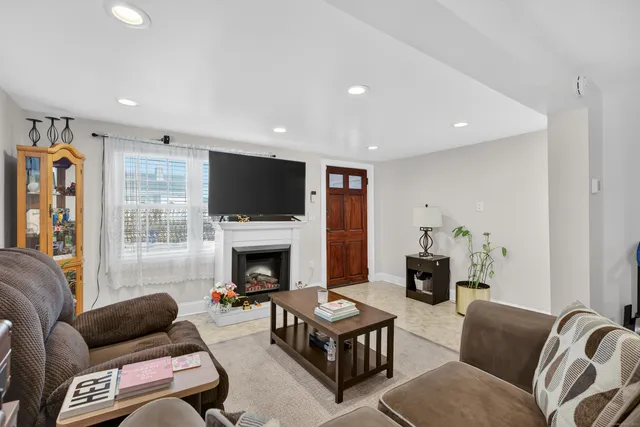 a living room with furniture flat screen tv and a fireplace