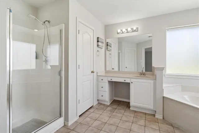 a bathroom with a granite countertop sink mirror and a shower