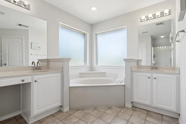 a bathroom with a sink vanity and mirror