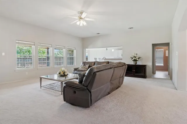 a living room with furniture and large windows