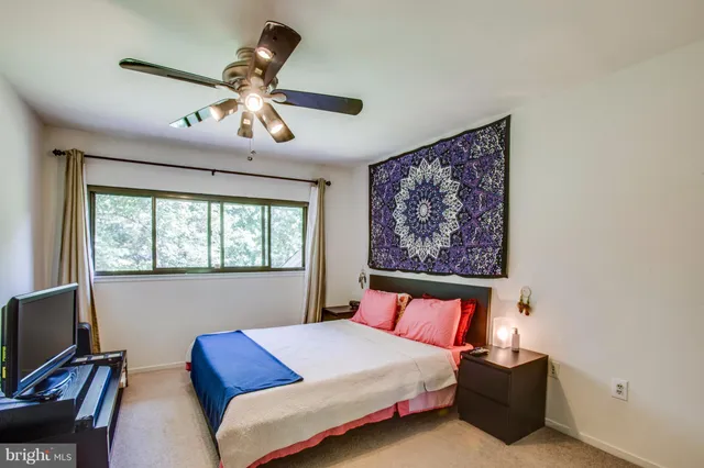 a bedroom with a bed workspace and a window