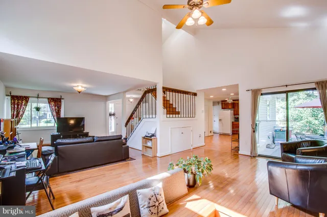 a living room with furniture a dining table and a large window