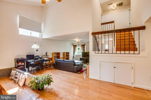 a living room with furniture window and wooden floor