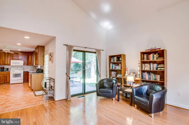 a living room with furniture and a book shelf