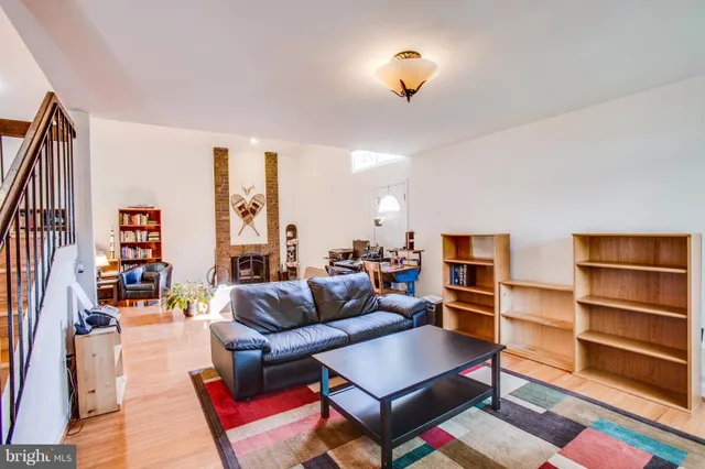a living room with furniture and a book shelf
