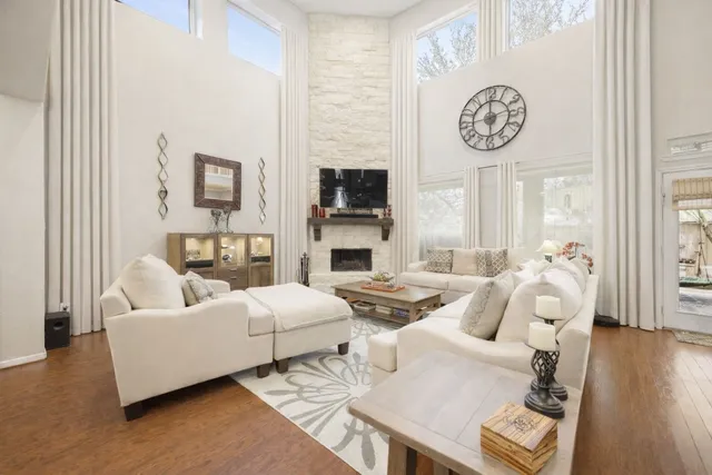 a living room with fireplace furniture and a wooden floor