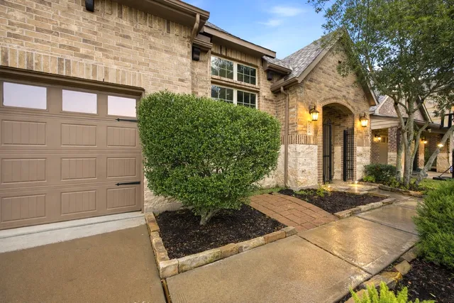 a kitchen with stainless steel appliances kitchen island granite countertop a table chairs sink and cabinets