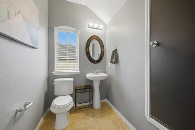 a living room with furniture and a refrigerator