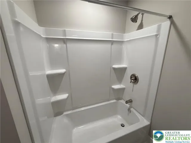 a bathroom with a bathtub and toilet