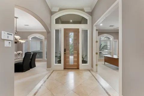 a view of a hallway with furniture and a window