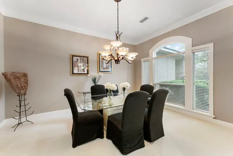 a dining room with furniture and window