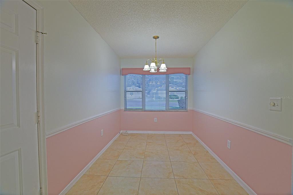 10046 Southeast 175 Street Summerfield, FL 34491 - Photo 12 of 27 a view of an empty room and chandelier fan