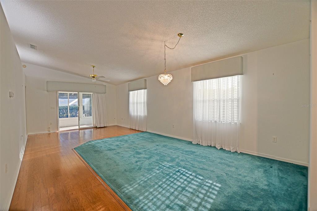10046 Southeast 175 Street Summerfield, FL 34491 - Photo 15 of 27 an empty room with chandelier fan and windows