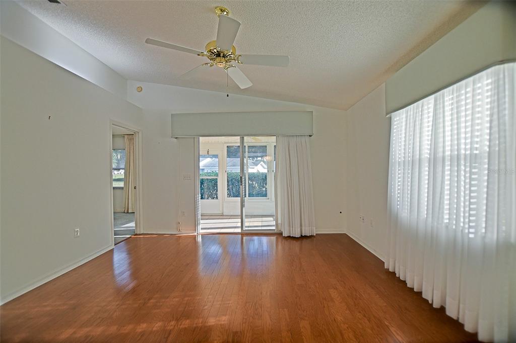 10046 Southeast 175 Street Summerfield, FL 34491 - Photo 16 of 27 wooden floor in an empty room with a window