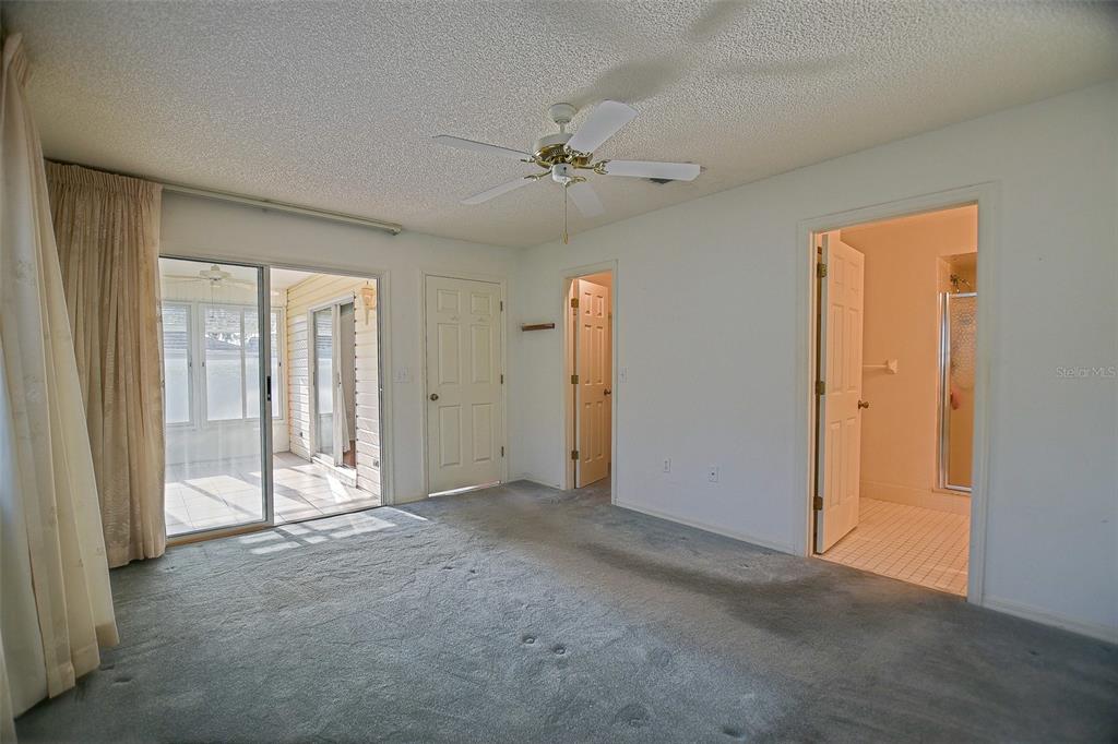 10046 Southeast 175 Street Summerfield, FL 34491 - Photo 17 of 27 an empty room with a empty space and a ceiling fan
