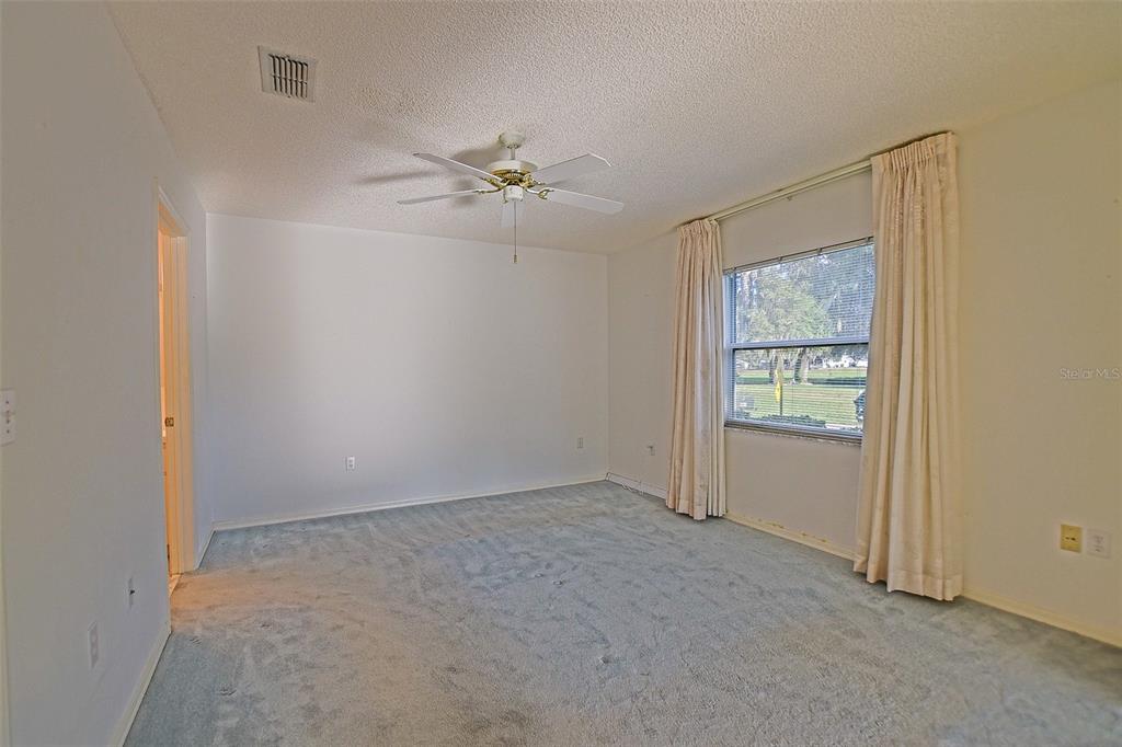 10046 Southeast 175 Street Summerfield, FL 34491 - Photo 18 of 27 an empty room with windows and fan
