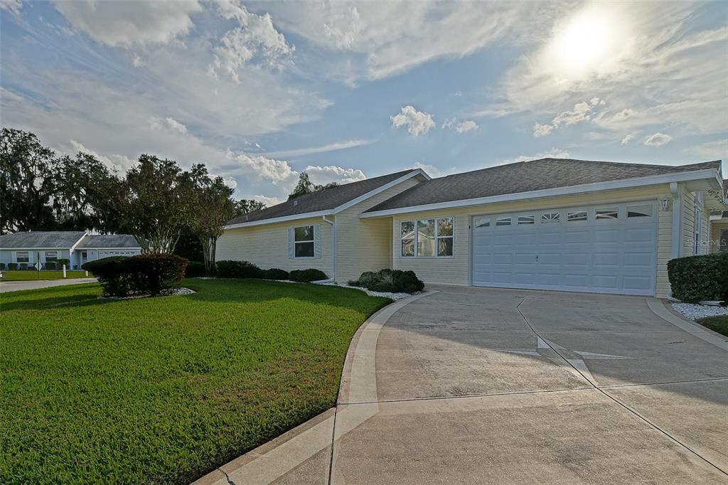 10046 Southeast 175 Street Summerfield, FL 34491 - Photo 2 of 27 a front view of a house with garden