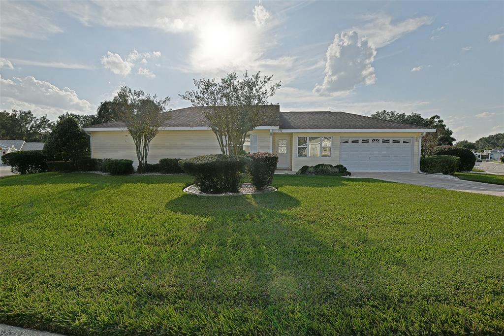 10046 Southeast 175 Street Summerfield, FL 34491 - Photo 3 of 27 a view of a house with a big yard and large trees
