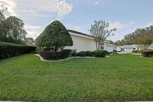 a view of a house with a garden and plants