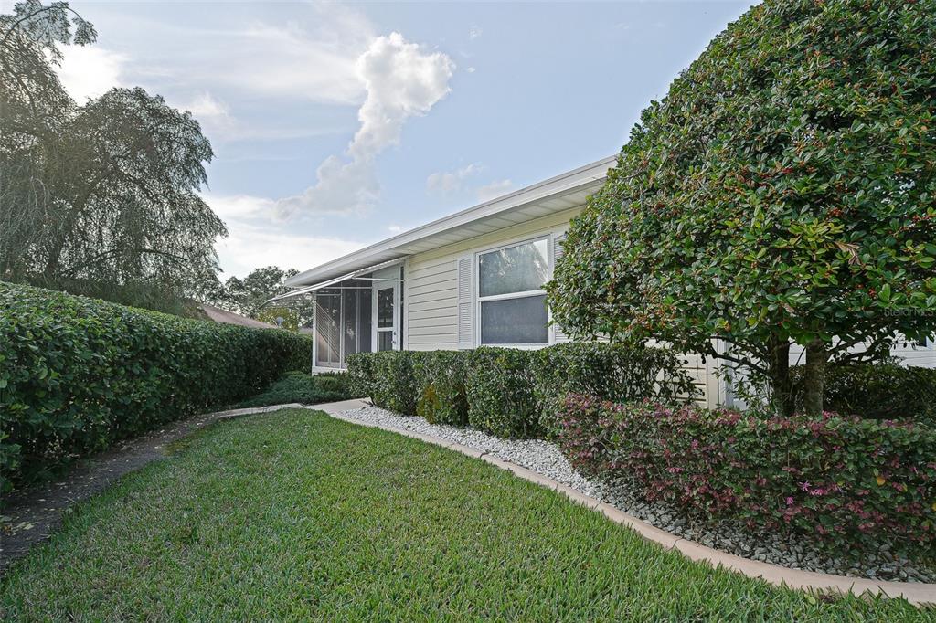 10046 Southeast 175 Street Summerfield, FL 34491 - Photo 6 of 27 a front view of a house with a yard and trees