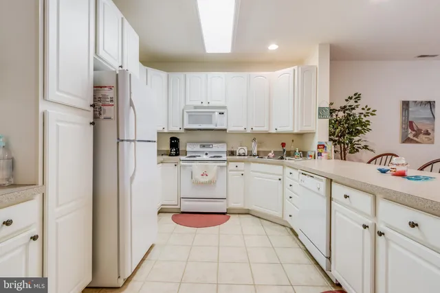 a white refrigerator freezer sitting in a kitchen