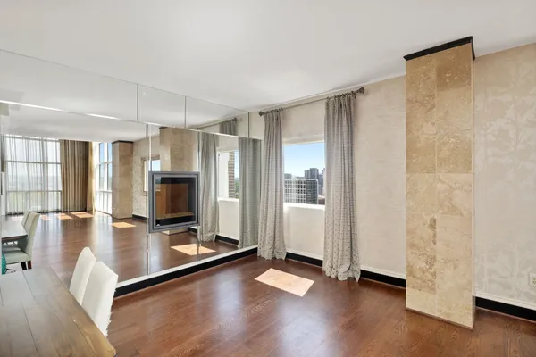 a view of a living room hardwood floor and a window